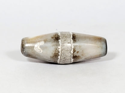 Ac-061526-1SPair, Bead A, 25.4×9.2mm, pale grey-white bicone, calcification stripe, honey-brown banding, unretouched