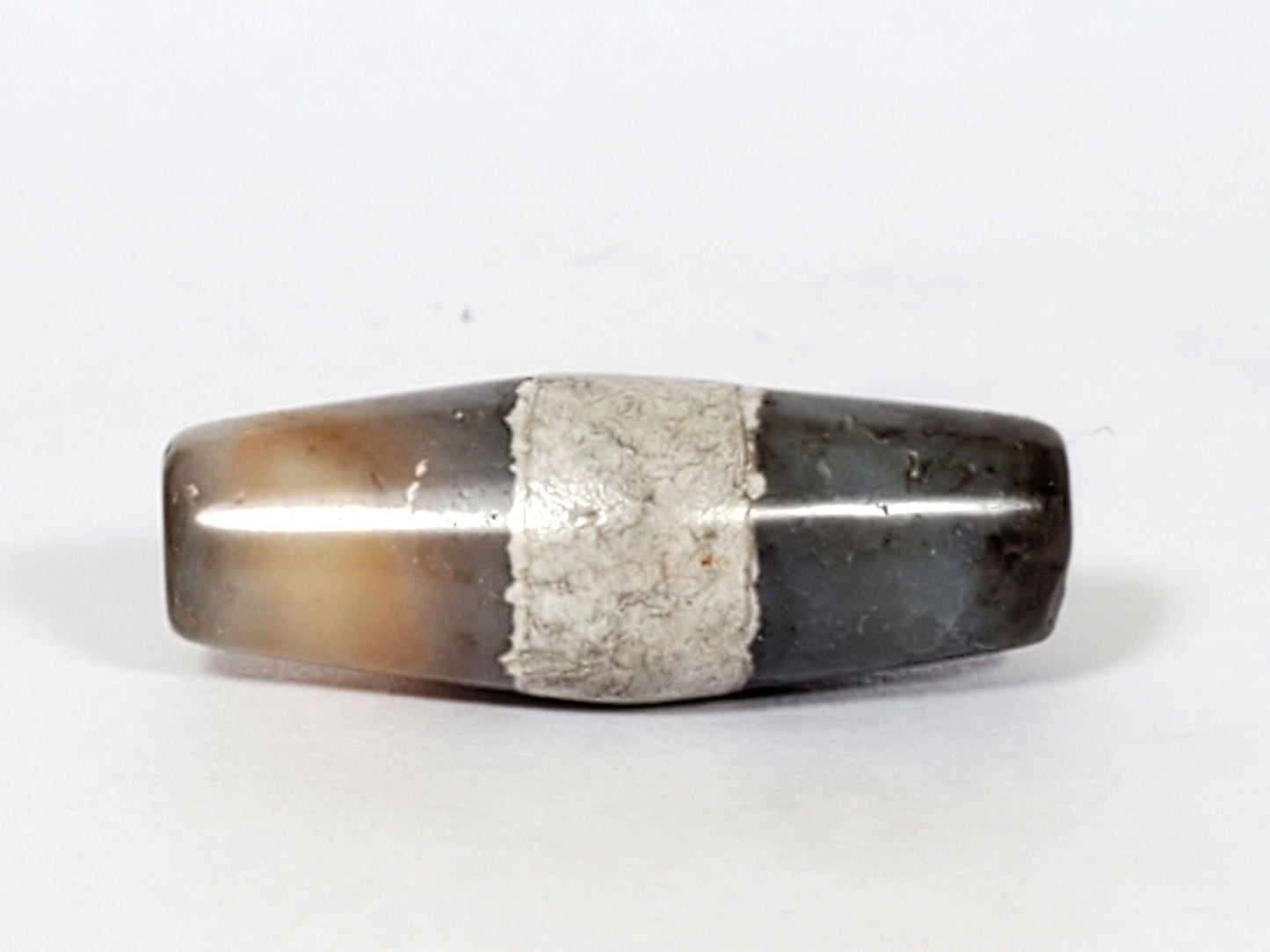 Ac-061526-1SPair, Bead B Face C, deep dark grey-brown ground, calcification band, end cap chip area visible, unretouched