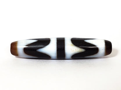 N-062226-DW3, double wave dzi, 57.8×12.6mm, very dark brown, cool white motif, honey-brown cap, face A, unretouched