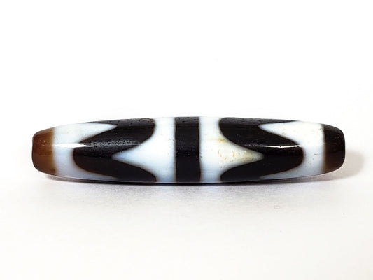 N-062226-DW3, double wave dzi, 57.8×12.6mm, very dark brown, cool white motif, honey-brown cap, face A, unretouched