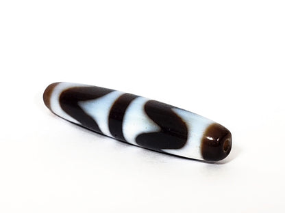 N-062226-DW3, angled view, honey-brown end cap with drill hole, very dark brown body, wave motif visible, unretouched