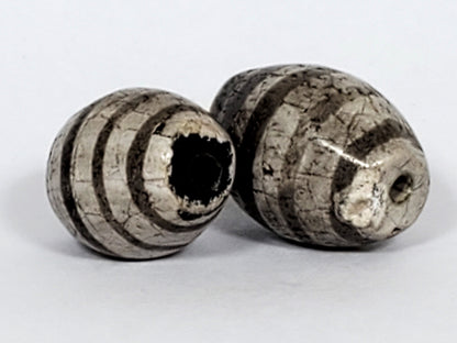 Ac-062626-9SChung2 pair ancient Chung dzi, drill end view, chip disclosed Bead A, dark end cap colouration, unretouched