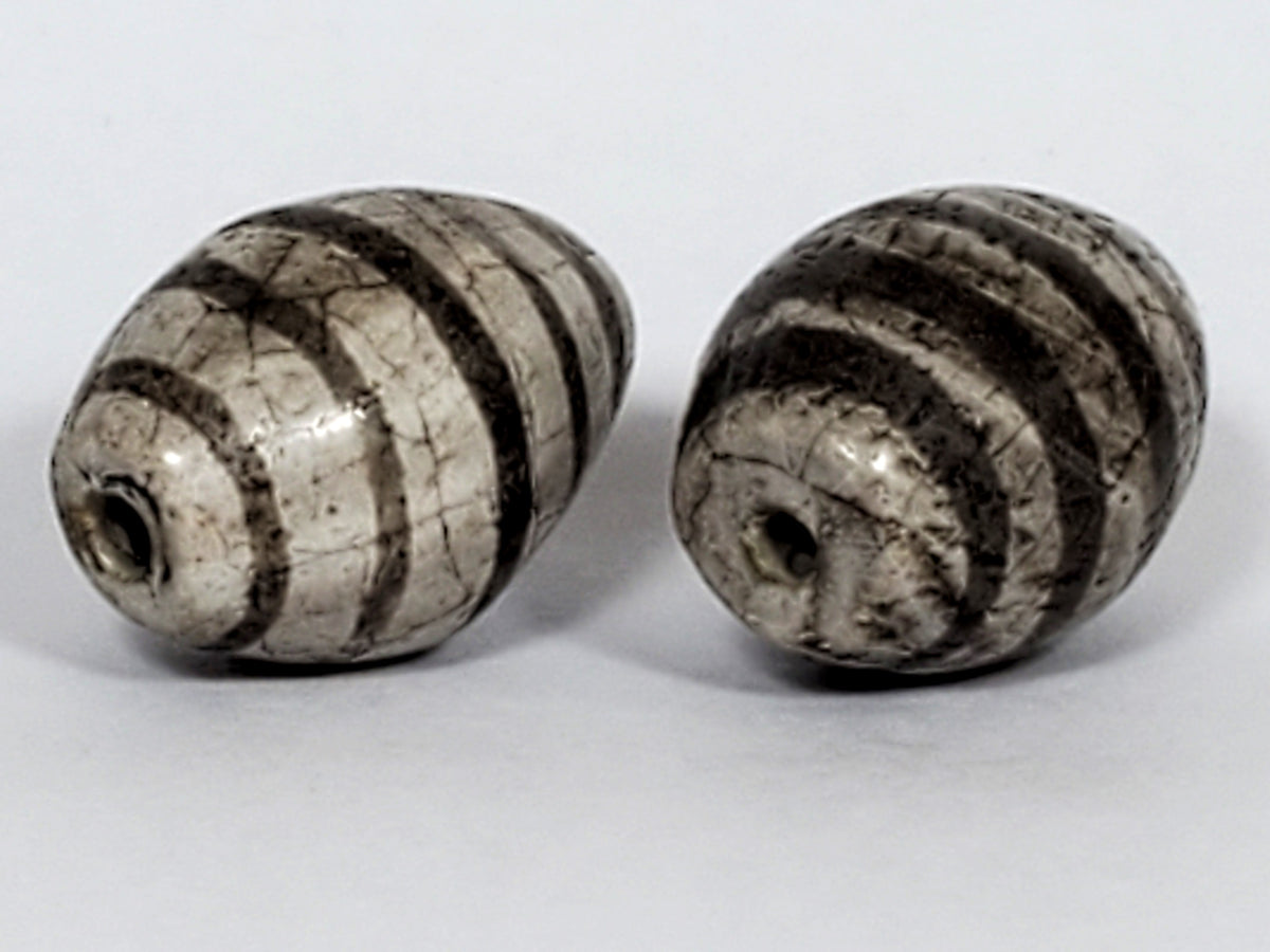 Ac-062626-9SChung2 pair ancient Chung dzi, drill end view, stripe softening age detail visible, unretouched
