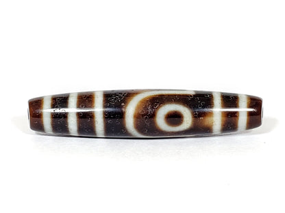 V-070226-2E dzi bead, rotation view, cream stepped line on dark brown ground, unretouched.