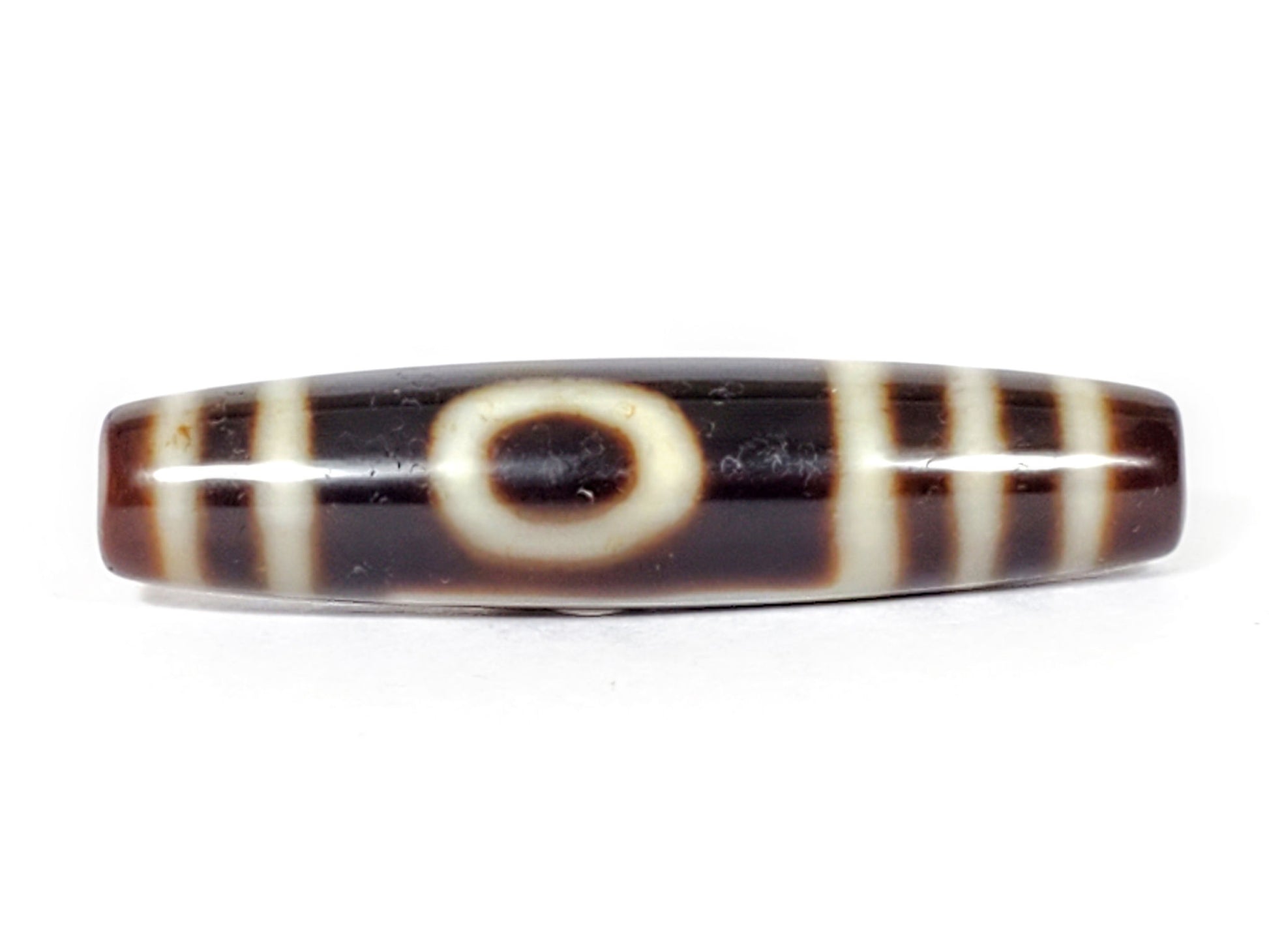 V-070226-OEM vintage one eye mountain dzi bead, front view, dark brown ground, cream eye motif, 48.6×11.3mm, unretouched.