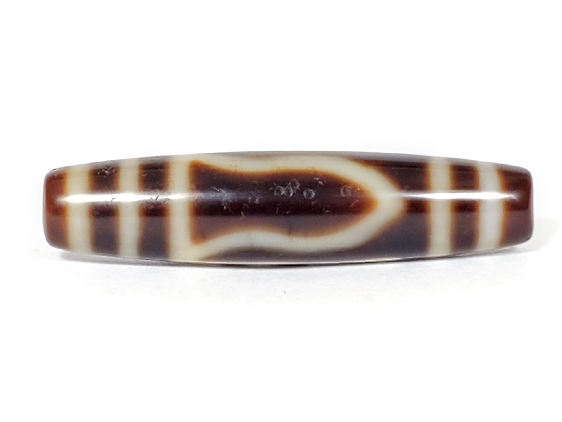 V-070226-OEM dzi bead, angled view showing mountain element and cream striping, dark brown, unretouched.