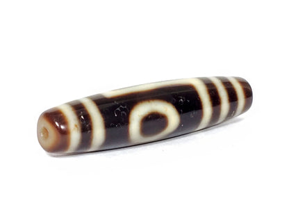 V-070226-OEM dzi bead, diagonal view showing drill hole and full stripe pattern, dark brown, unretouched.