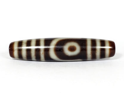 V-031122-2E vintage two eye dzi bead, front view, brown ground, triple-bar ends, 50.0×11.4mm, unretouched.