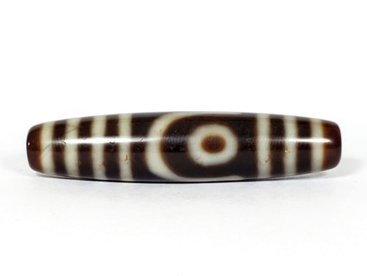 V-031122-2E vintage two eye dzi bead, front view, brown ground, triple-bar ends, 50.0×11.4mm, unretouched.
