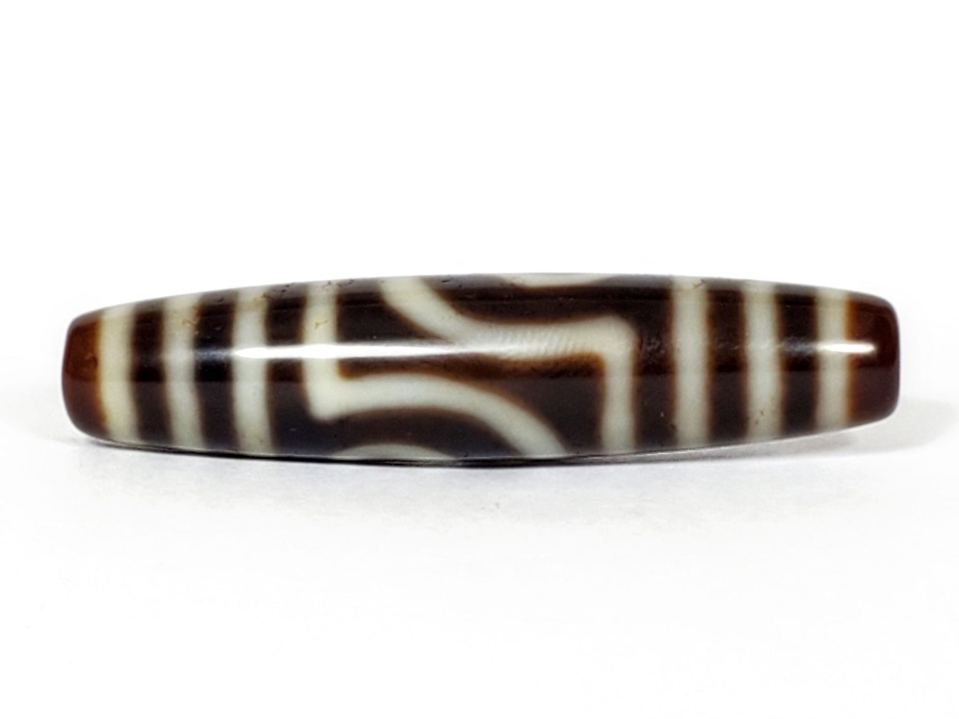 V-031122-2E dzi bead, front view showing stepped-line face, dark brown ground, unretouched photo.