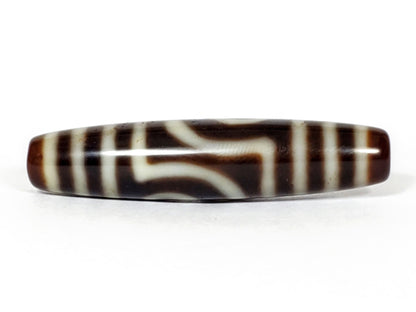 V-031122-2E dzi bead, front view showing stepped-line face, dark brown ground, unretouched photo.