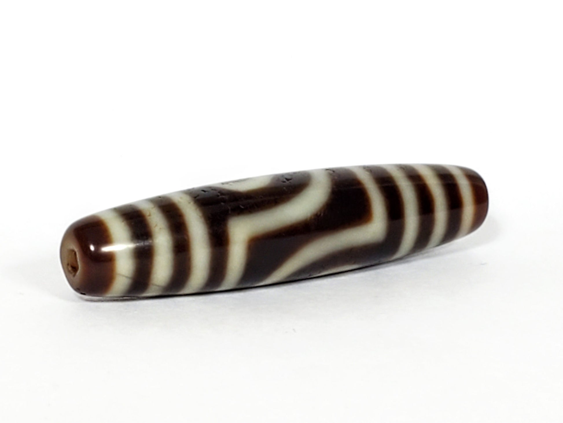 V-031122-2E dzi bead, diagonal view showing drill hole and full stripe pattern, unretouched.