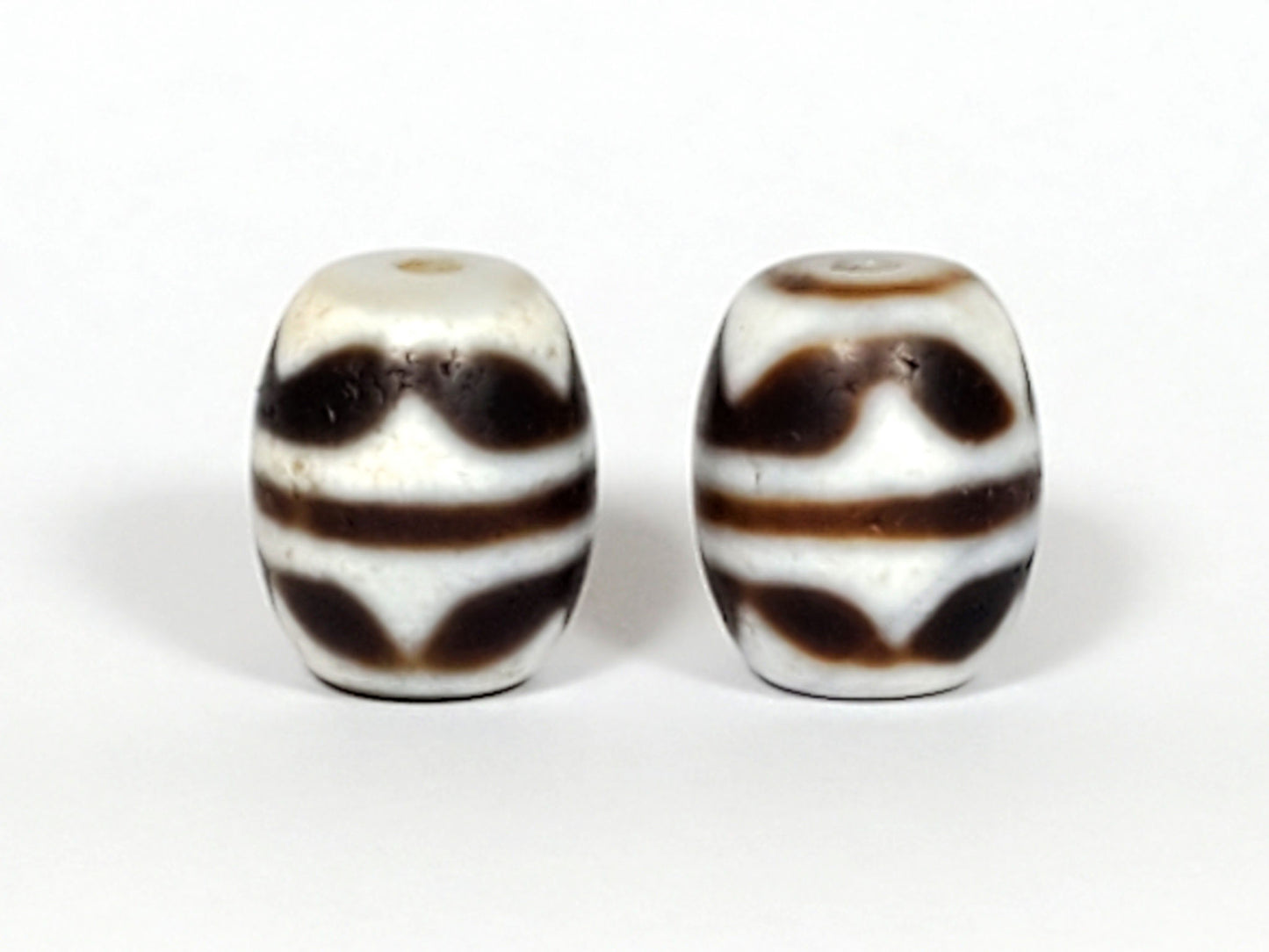V-041122-DTT pair vintage double tiger tooth dzi, front face, cream-white ground, 14.8×12.2mm, unretouched