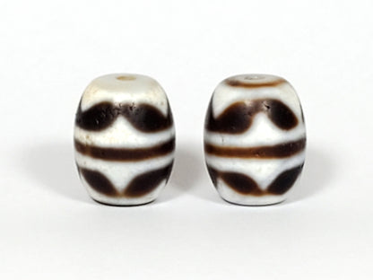 V-041122-DTT pair vintage double tiger tooth dzi, front face, cream-white ground, 14.8×12.2mm, unretouched