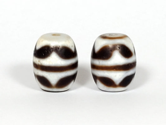 V-041122-DTT pair vintage double tiger tooth dzi, front face, cream-white ground, 14.8×12.2mm, unretouched