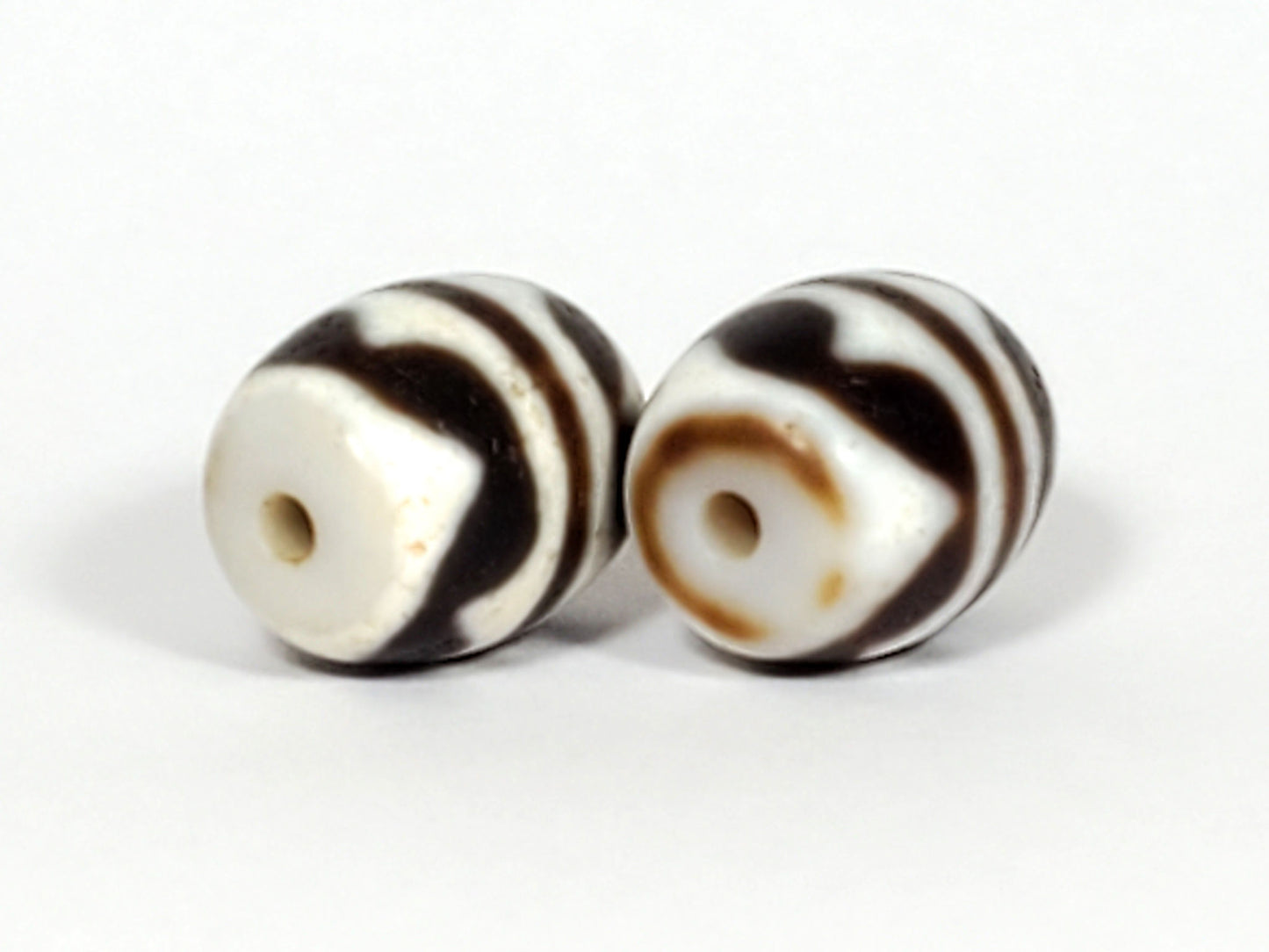 V-041122-DTT pair vintage double tiger tooth dzi, opposite drill end, end cap variation between beads, unretouched