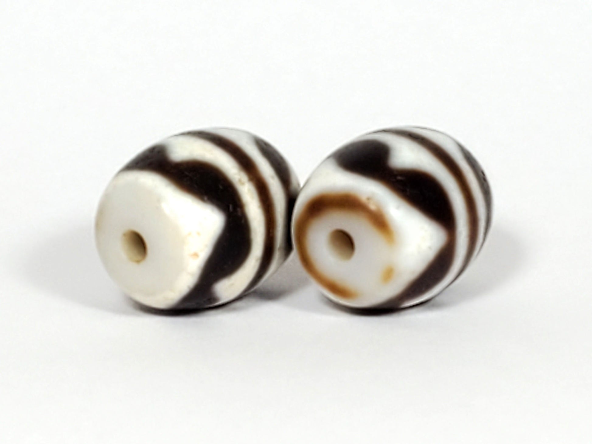 V-041122-DTT pair vintage double tiger tooth dzi, opposite drill end, end cap variation between beads, unretouched