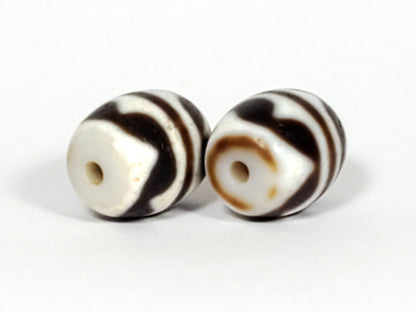 V-041122-DTT pair vintage double tiger tooth dzi, opposite drill end, end cap variation between beads, unretouched