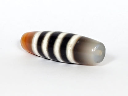 N-050222-7SChung, right tip 3/4 view, cool milky grey-white translucent end cap, stripes wrapping tip, unretouched