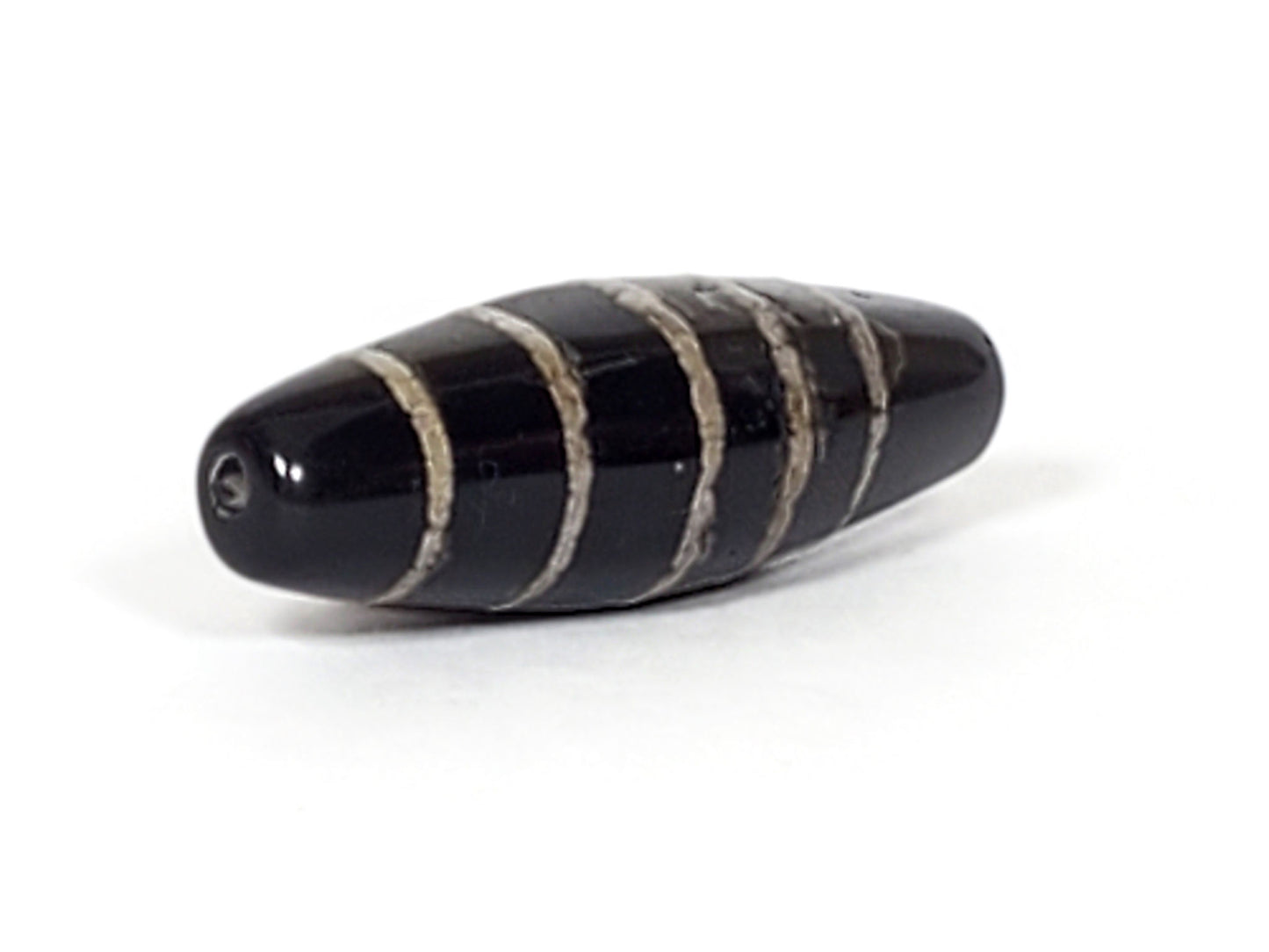 At-062626-9SChung Bead B side view, stripe texture, age-weathered edges, deep black agate, unretouched
