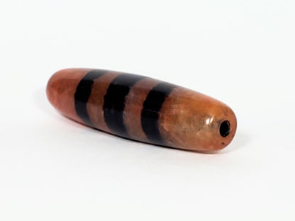 At-070622-5SChung, right tip, blunt rounded end, centrally placed drill hole, warm terracotta body, unretouched