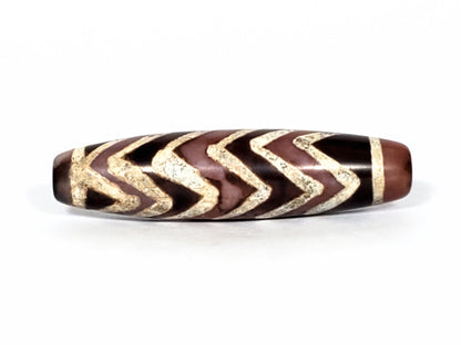 At-070822-6TS face B, six chevrons, warm chocolate-brown ground, sandy-cream motif lines, semi-gloss, unretouched