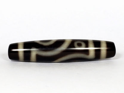 V-070226-4E2 dzi bead, curved connecting-line face, black ground, cream bands, unretouched photo.