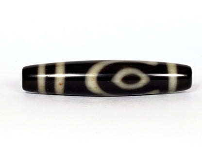 V-070226-4E2 dzi bead, eye motif face, black agate with cream rings, unretouched photo.