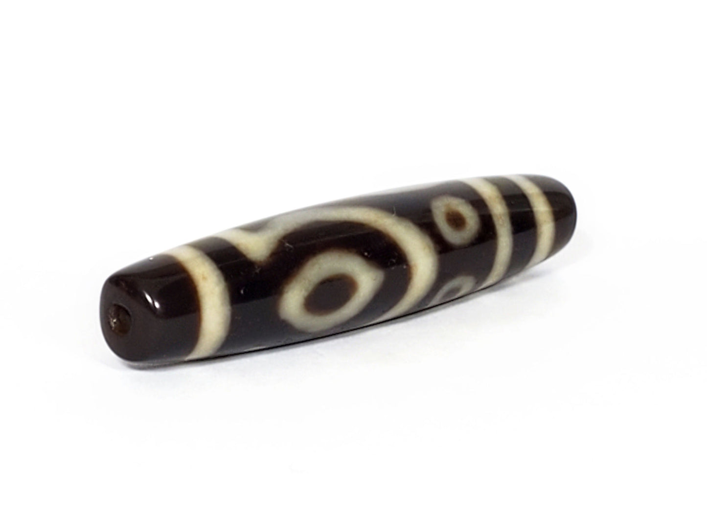 V-070226-4E2 dzi bead, full diagonal view, cream eye and stripe motif on black, unretouched.