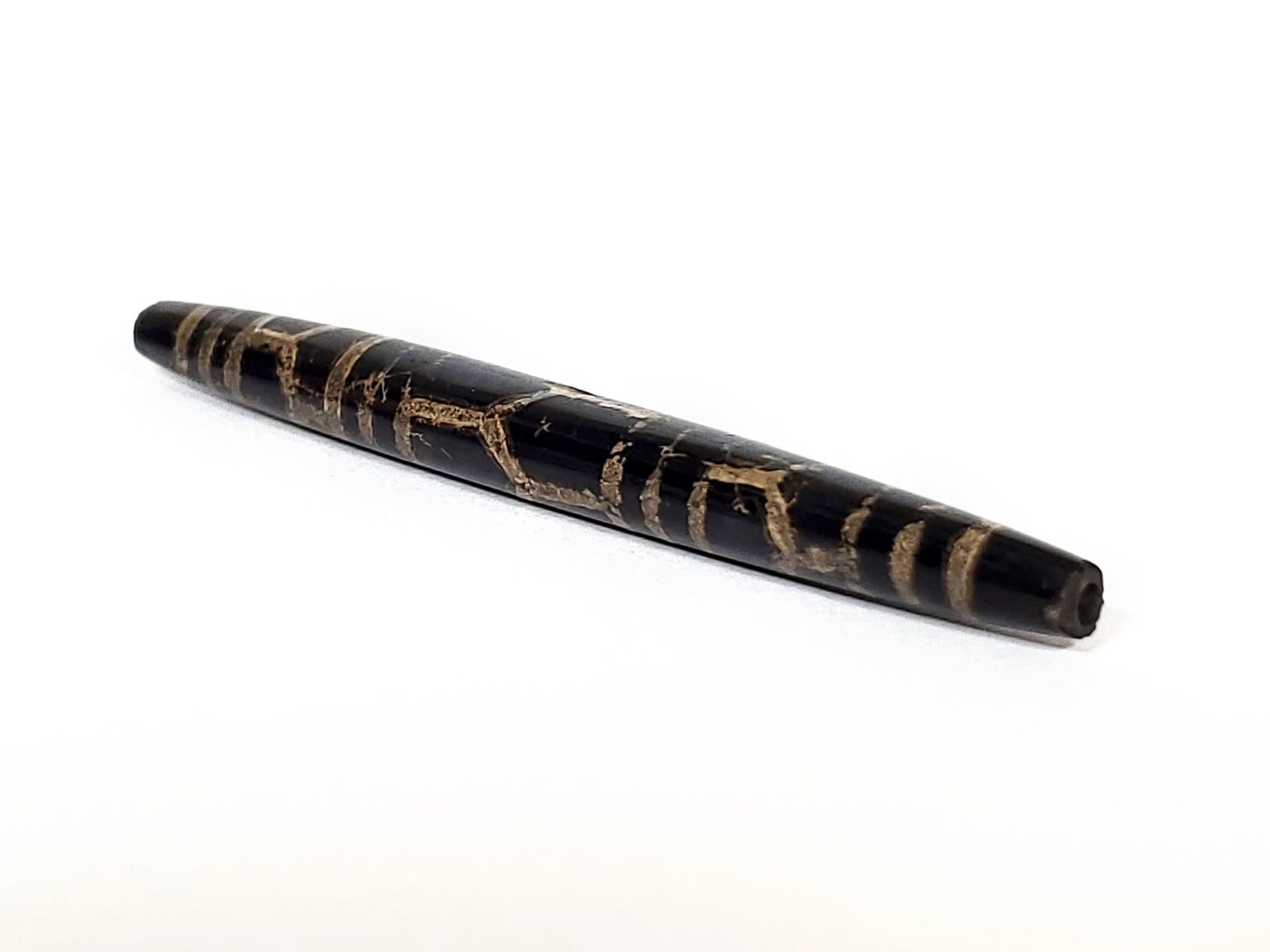 Ac-062926-3LG angled drill-end, pitch-black tapered barrel, aged tan motif lines, ancient longevity dzi, unretouched