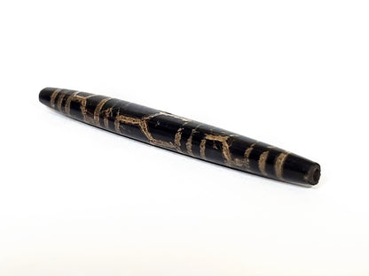 Ac-062926-3LG angled drill-end, pitch-black tapered barrel, aged tan motif lines, ancient longevity dzi, unretouched
