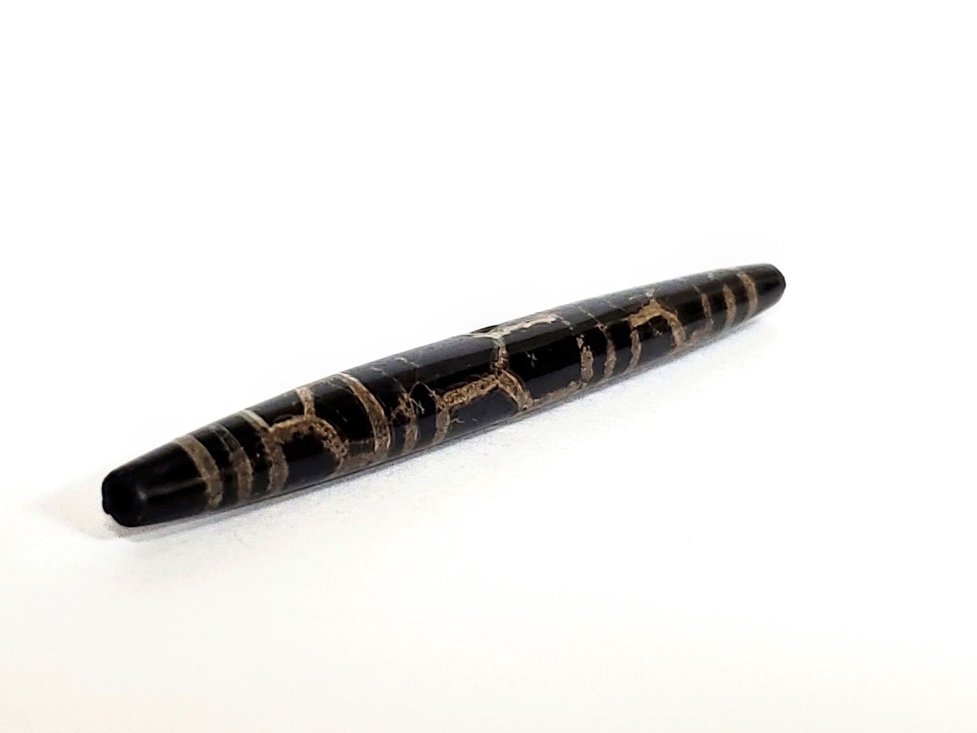 Ac-062926-3LG opposite end angled view, full taper visible, triple longevity pattern, pitch-black agate, unretouched