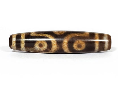 N-062226-6E2, face B, six eye motif, warm honey-gold lines on medium warm brown ground, semi-gloss, unretouched