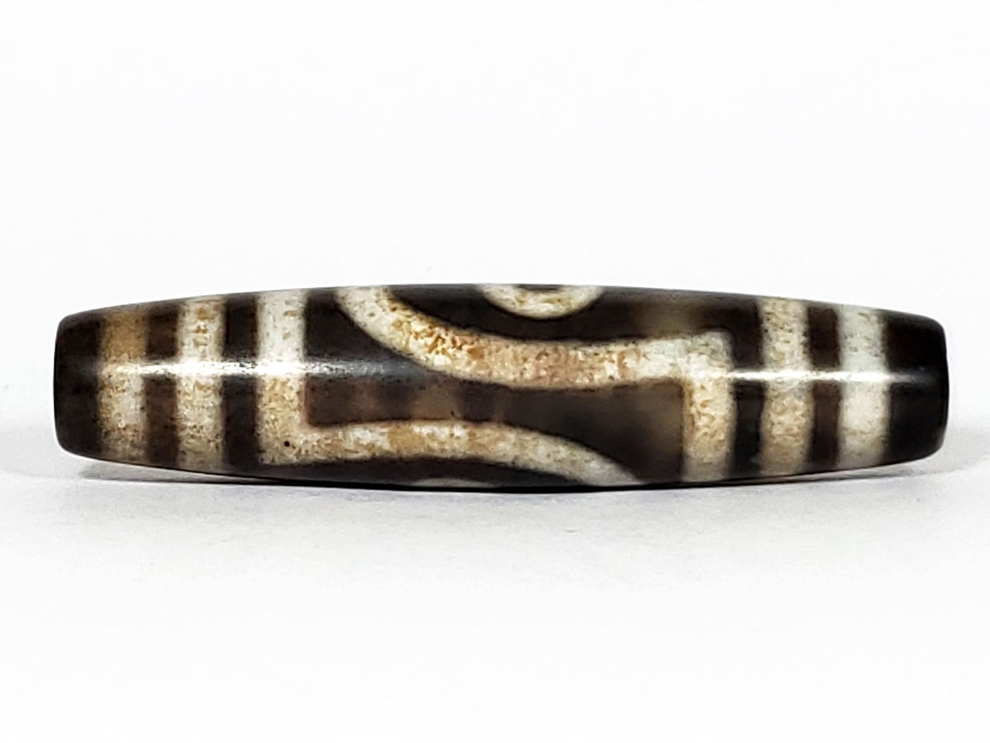 N-062126-2E2 dzi bead, straight side profile, tighter eye face visible, unretouched