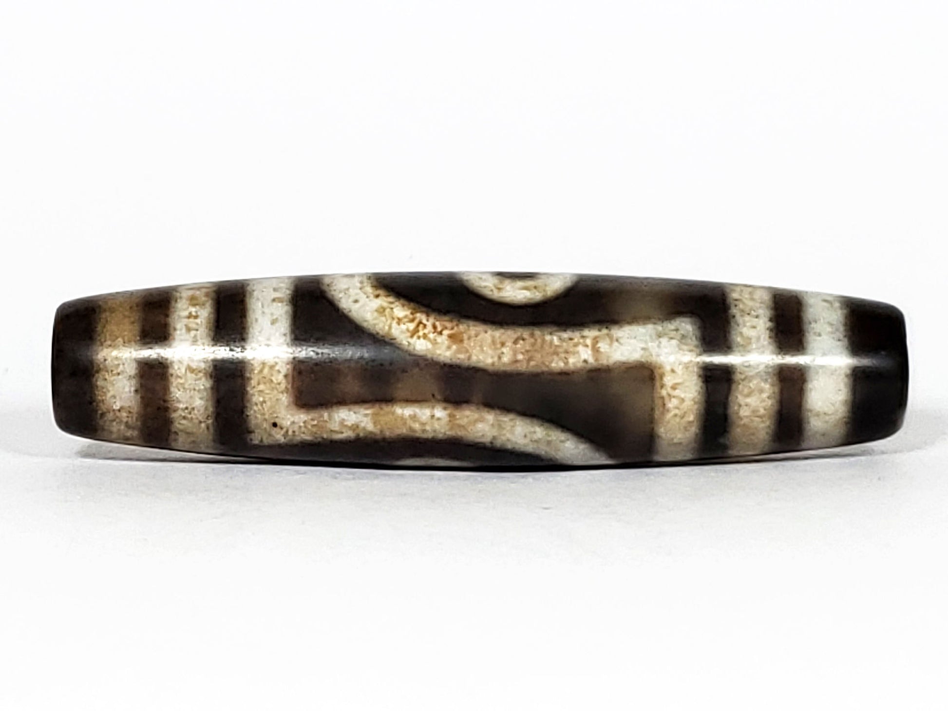 N-062126-2E2 dzi bead, straight side profile, tighter eye face visible, unretouched