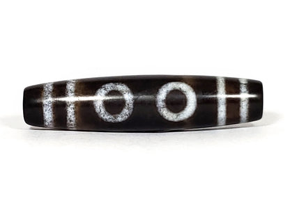 N-062226-6E, face B, three closed concentric ring eyes, H-bar dividers, very deep dark brown ground, unretouched