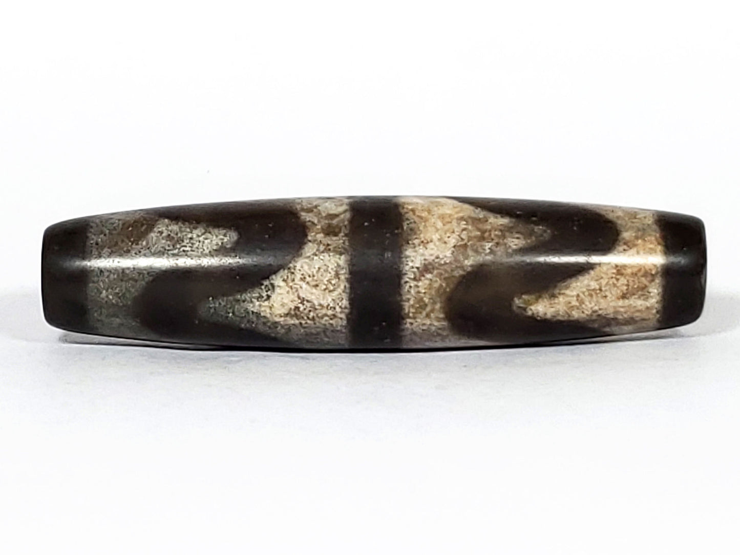 N-062226-DW2, face B, double wave motif, warm sandy-beige granular field, very dark brown agate ground, unretouched