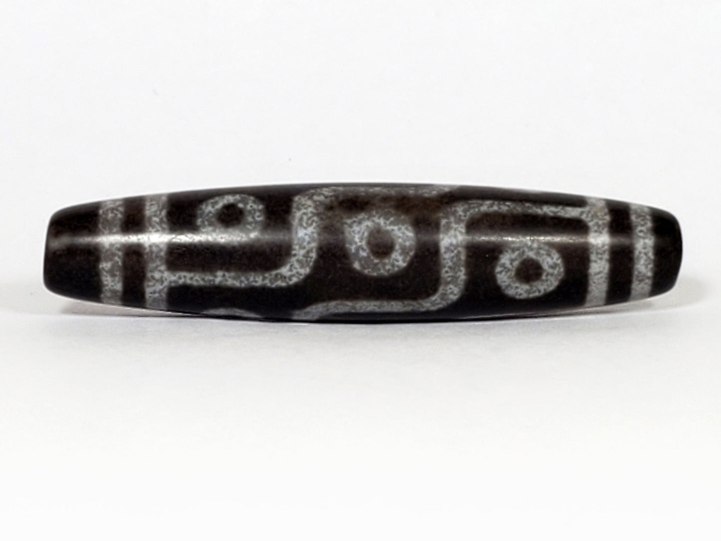 N-062226-9E, face C, nine eye dzi, cool dark grey-black agate, three eyes visible, asymmetric fusiform, unretouched