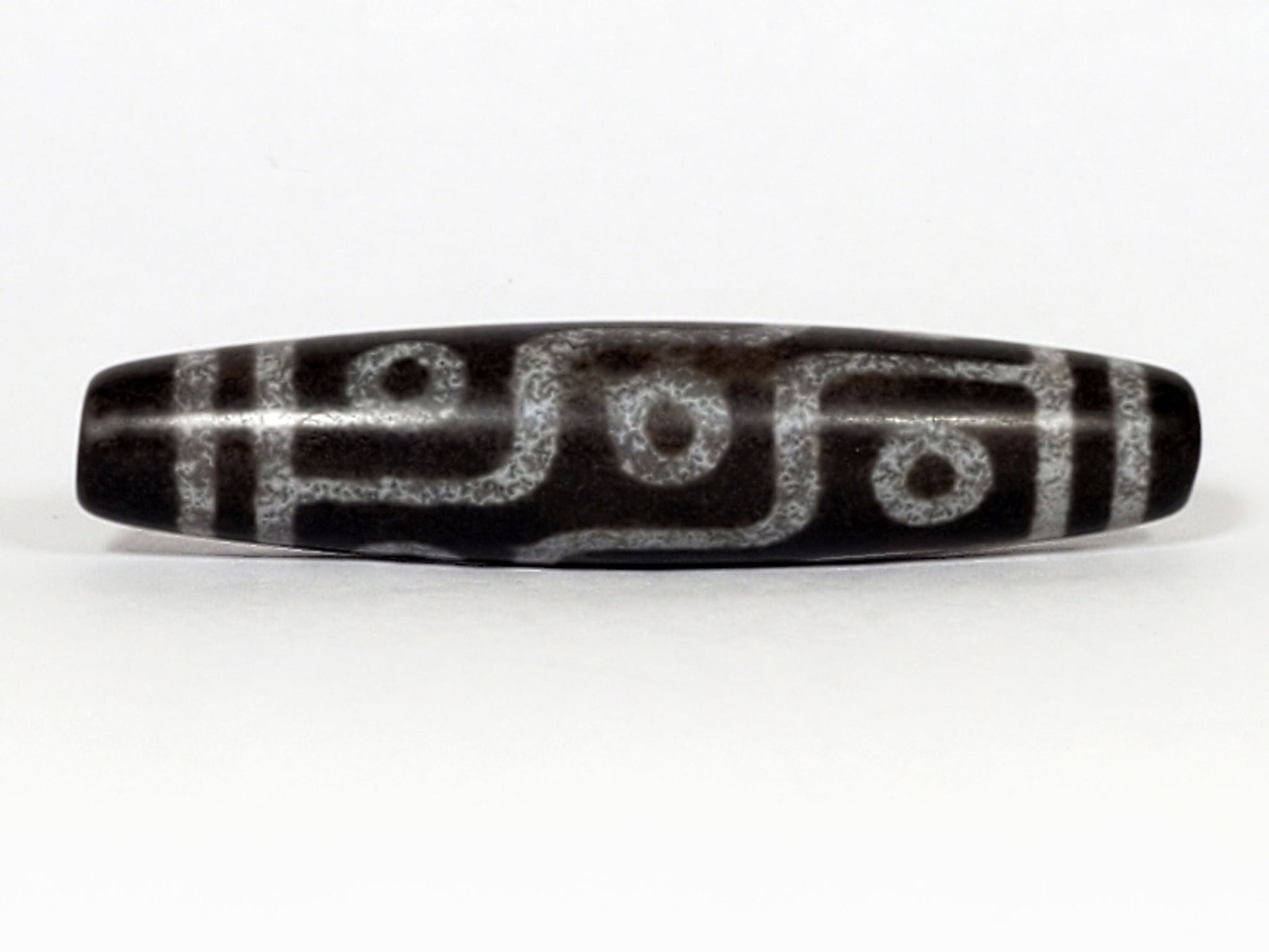 N-062226-9E, face C, nine eye dzi, cool dark grey-black agate, three eyes visible, asymmetric fusiform, unretouched