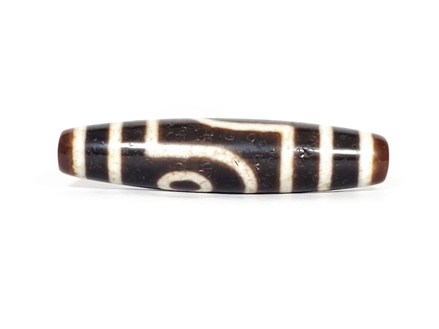 V-070426-2E3 dzi bead, front view, cream eye ring on brown-black ground, unretouched photo.