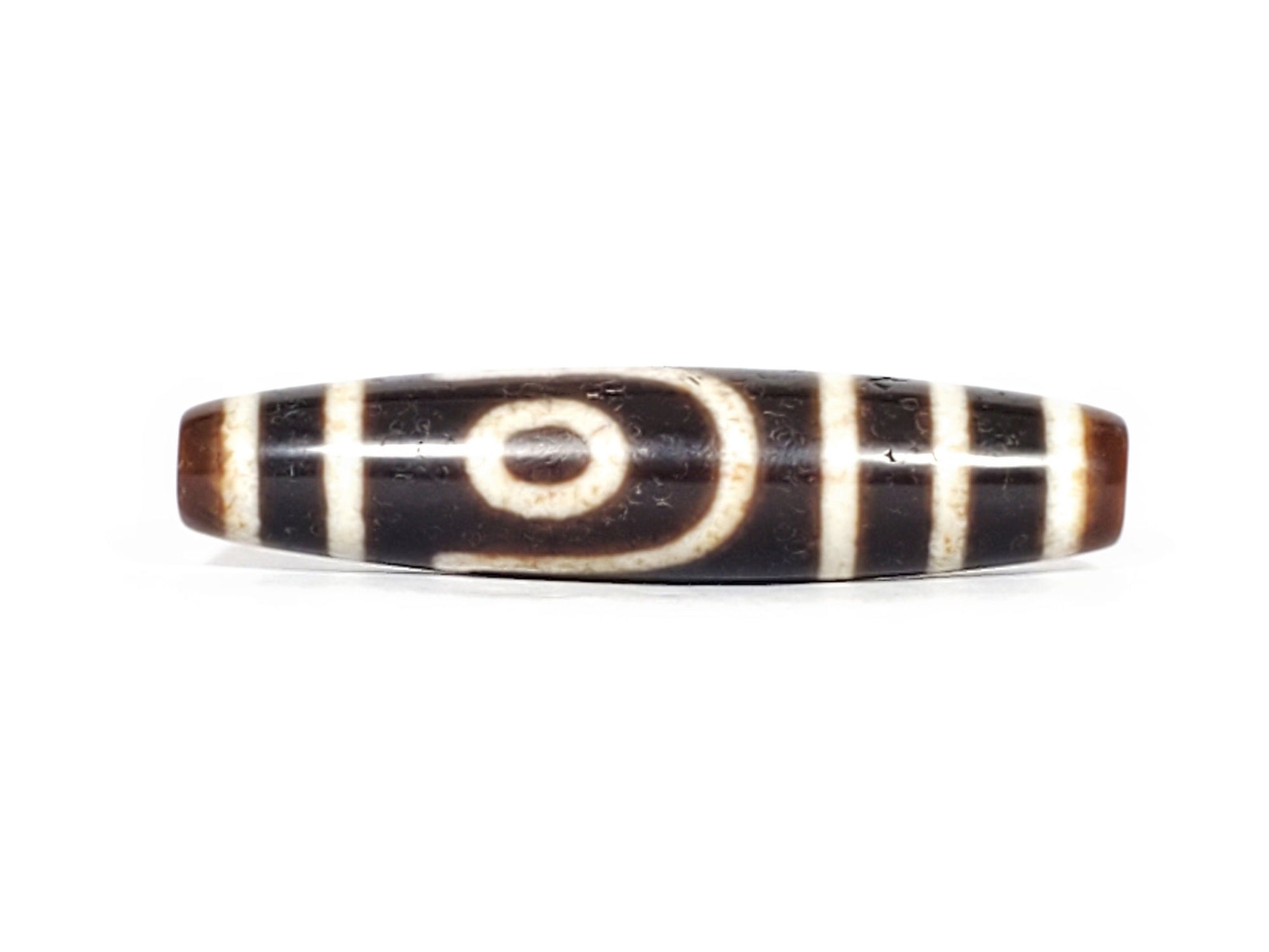 V-070426-2E3 dzi bead, front view showing stepped-line face, brown-black agate, unretouched.