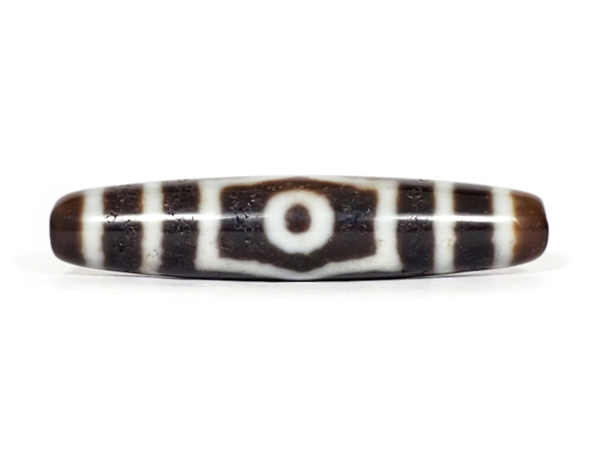 V-070226-ThE-001 vintage three eye dzi bead, front view, single eye with shield border, 56.4×12.1mm, unretouched.
