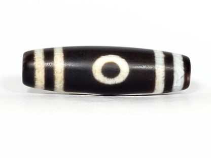 N-070226-3E new three eye dzi bead, front view, black ground with cream eye motif, 44.2×13.1mm, unretouched.