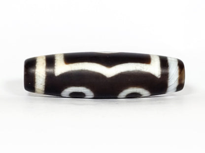 N-070226-3E dzi bead, reverse face showing scalloped wave line, black agate, unretouched photo.
