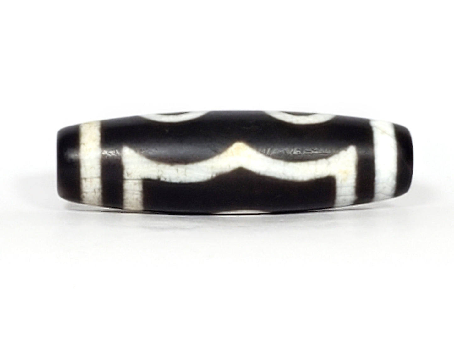 N-070226-3E dzi bead, angled view showing full stripe pattern, black agate, unretouched.