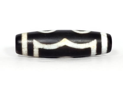 N-070226-3E dzi bead, angled view showing full stripe pattern, black agate, unretouched.