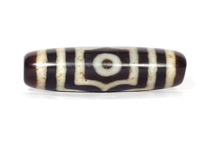 V-070226-3E vintage three eye dzi bead, front view, dark brown and black ground, 41.3×11.9mm, unretouched.
