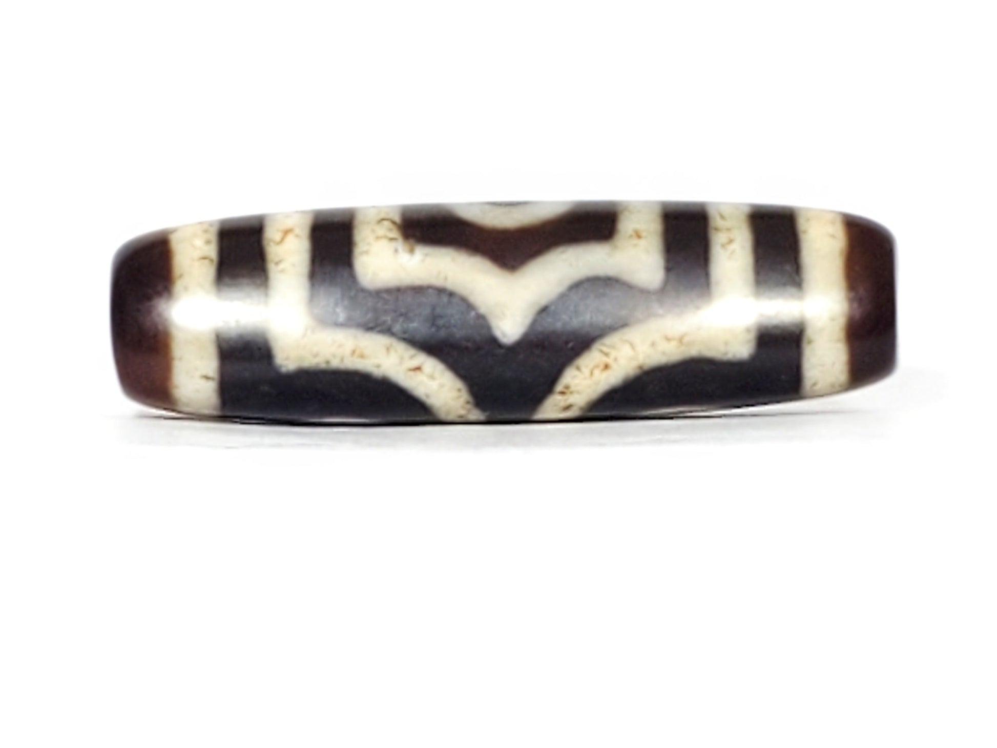 V-070226-3E dzi bead, wave-pattern face, black ground with cream chevron lines, unretouched.