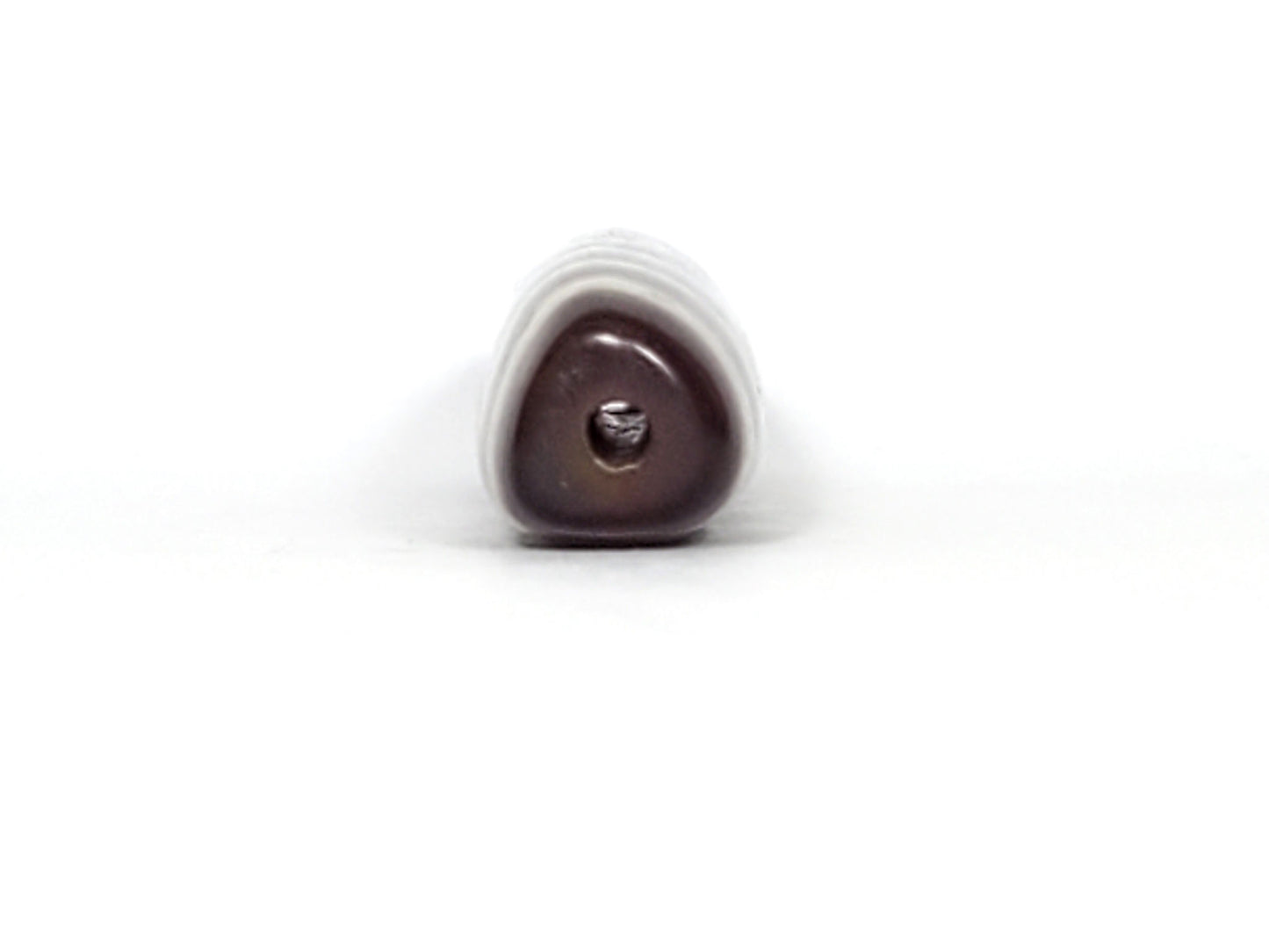 V-070226-3E dzi bead, end view showing triangular cross-section and drill hole, unretouched.