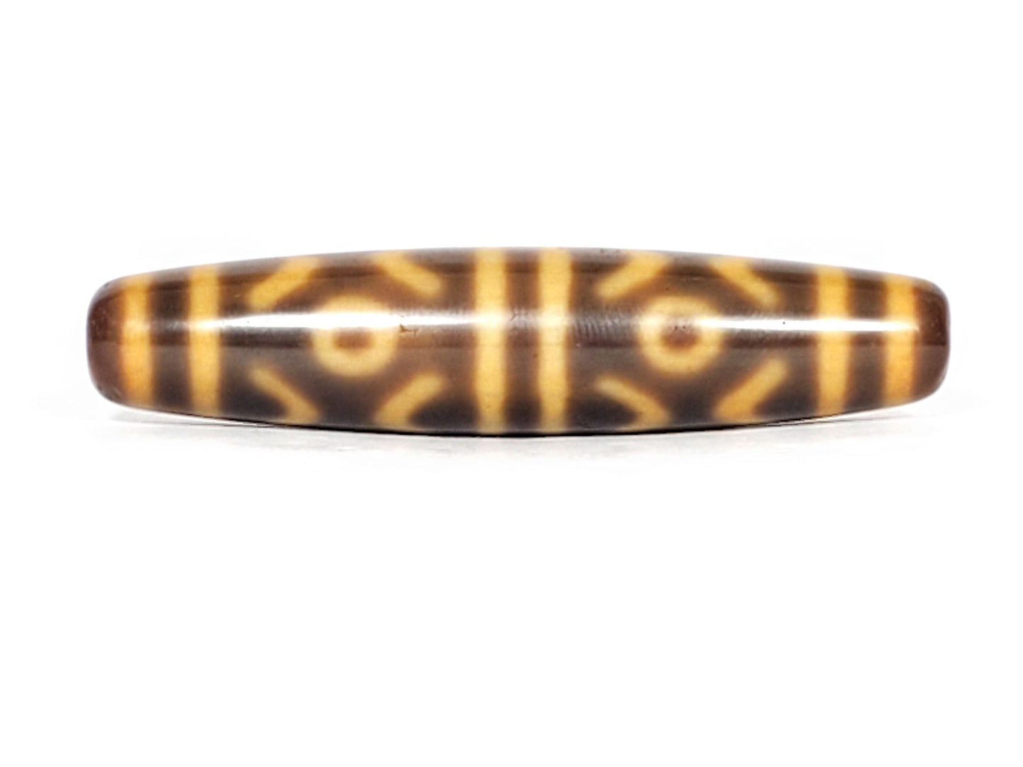 At-053126-6ETT, antique six eye & tiger tooth dzi, 57.9×12.9mm, honey-gold motif on chocolate-brown, unretouched